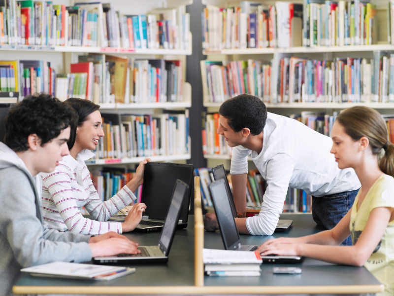 Students Using Laptops In Library